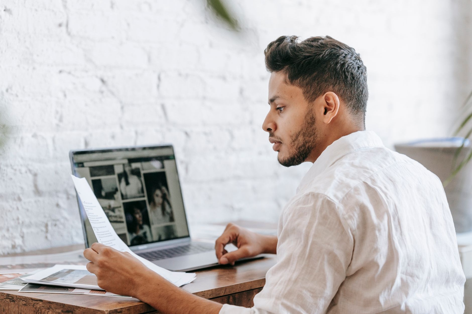 a focused SEO manager reviewing a multi-monitor setup with a spreadsheet of URL mappings and a browser open to Google Se